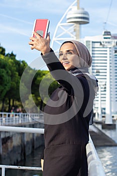 Gorgeous smiling Arabic woman taking selfie