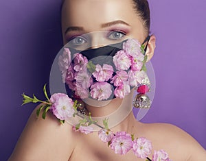 Gorgeous spring girl, with flowers on a mask. Spring that we cannot breathe, the smell of flowers.