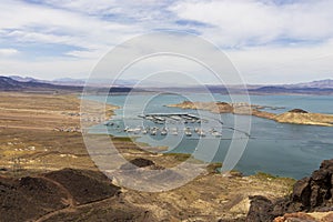 a gorgeous spring landscape at Lake Mead with vast blue water and majestic mountain ranges and boats and yachts docked