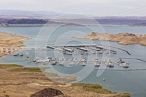 a gorgeous spring landscape at Lake Mead with vast blue water and majestic mountain ranges and boats and yachts docked