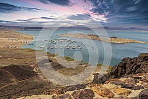 a gorgeous spring landscape at Lake Mead with vast blue water and majestic mountain ranges and boats and yachts docked