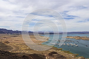 a gorgeous spring landscape at Lake Mead with vast blue water and majestic mountain ranges and boats and yachts docked