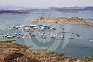 a gorgeous spring landscape at Lake Mead with vast blue water and majestic mountain ranges and boats and yachts docked