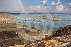 a gorgeous spring landscape at Lake Mead with vast blue water and majestic mountain ranges and boats and yachts docked