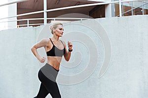 Gorgeous strong young sports woman running