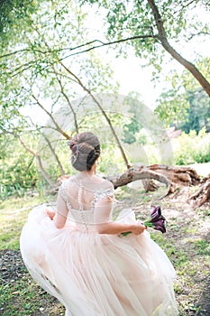 Gorgeous stylish bride in vintage white dress walking in the park. Beautiful wedding bride running in the forest .