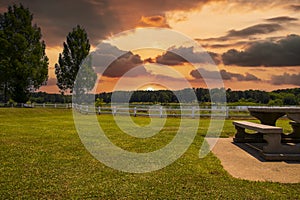 A gorgeous summer landscape at Lake Acworth with rippling blue lake water surrounded by lush green grass and trees