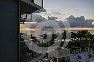 A gorgeous summer landscape with a stunning sunrise over the Atlantic ocean with powerful clouds, ocean water, balconies