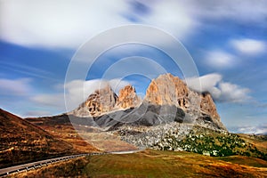 Gorgeous sunny view of Dolomite Alps with pastures. Colorful autumn scene of Langkofel, Sassolungo mountain range. Sella pass. photo