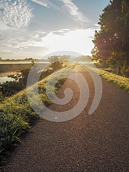 Gorgeous sunrise over the pathway next the river Dyle, Mechelen