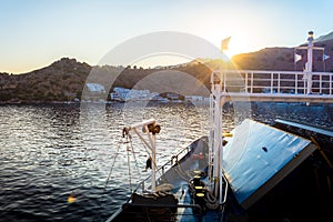 Gorgeous sunset from the deck of a ship, as it approaches the greek village of Loutro, Chania, Crete, Greece