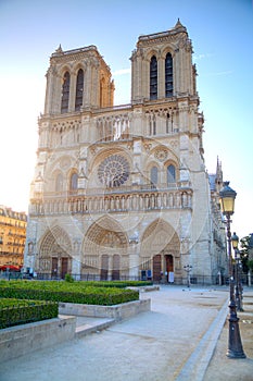 Gorgeous sunset over Notre Dame cathedral with puffy clouds, Par