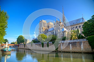 Gorgeous sunset over Notre Dame cathedral with puffy clouds, Par