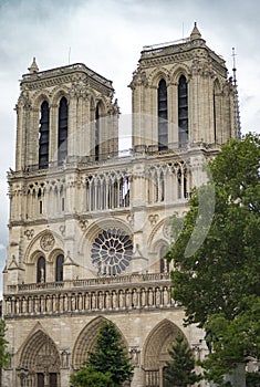 Gorgeous sunset over Notre Dame cathedral with puffy clouds, Paris, France.Notre Dame de Paris - Gothic Catholic Cathedral with