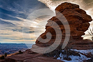 Gorgeous sunset on a rock formation in Canyonlands National Park in the winter with snow in Moab Utah