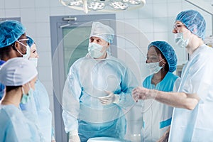 Gorgeous surgeon and his team making up a plan of work