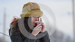 Gorgeous teen wit fur hat drinking hot tea