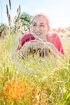 Gorgeous teenage girl smiling in the grass, instagram effects