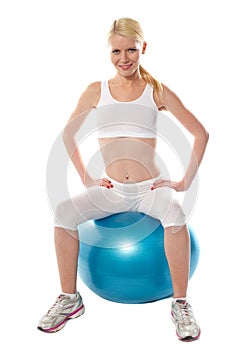 Gorgeous teenager sitting on exercise ball