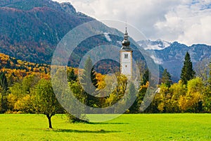 Gorgeous view of colorful autumnal scene of famous Church of St John the Baptist at Bohinj Lake