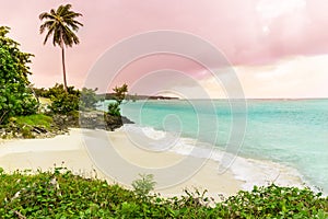 Gorgeous view on Guardalavaca beach with stormy turquoise ocean and pinkish sunset sky background