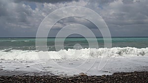 Gorgeous view of ocean waves surge and break into the rocky shoreline. Sea waves running towards a rocky ocean shore