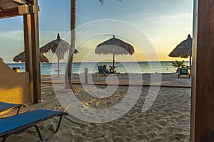 Gorgeous view on sandy beach and Atlantic Ocean from a room. Sun beds and umbrellas on turquoise water and blue sky background.