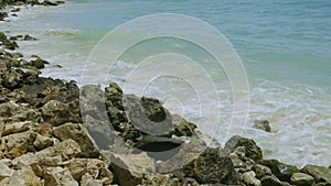 Gorgeous view of turquoise waves of Atlantic Ocean breaking on stones. Beautiful nature landscape backgrounds. Aruba island.