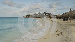 Gorgeous view of white sand coastline and turquoise waves of Atlantic Ocean. Eagle Beach of Aruba Island.