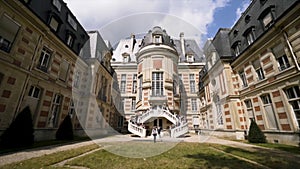 Gorgeous wedding being celebrated in a beautiful castle. Action. Group of people standing on the stairs ready for