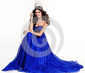 Gorgeous winner of beauty contest wearing luxurious sequin dress and precious crown