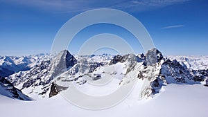 Winter mountain landscape in the Alps of Switzerland with peaks and glaciers