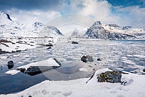 Gorgeous winter scene over polar circle. Frozen Boosen fjord on Flakstadoya island. photo