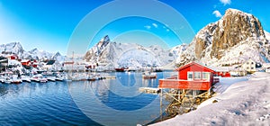 Gorgeous winter view on Hamnoy village with port and Festhaeltinden and Olstinden peaks on background