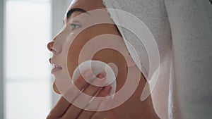Gorgeous woman cleaning face in bathroom closeup. Girl removing impurities