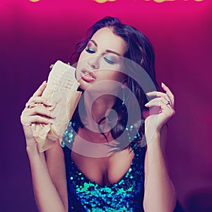 Gorgeous woman eating kebab in night club