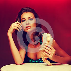 Gorgeous woman eating kebab in night club