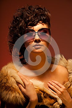 Gorgeous woman in fur and glasses