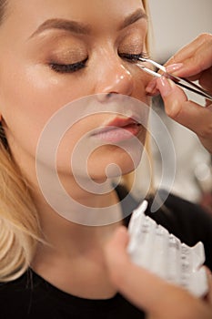 Gorgeous woman getting professional makeup done