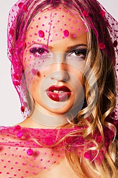 Gorgeous woman in a pink veil