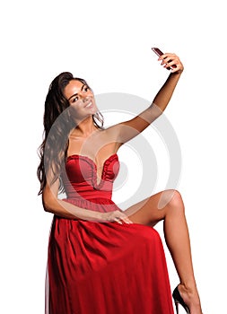 gorgeous woman in red dress. Studio picture, grey background