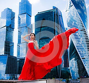 Gorgeous woman in red fluttered dress. Freedom concept.