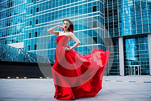 Gorgeous woman in red fluttered dress. Freedom concept. Fashion