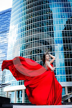 Gorgeous woman in red fluttered dress. Freedom concept. Fashion