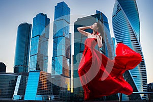 Gorgeous woman in red fluttered dress. Freedom concept. Fashion