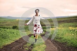 Gorgeous woman running on a countryside road