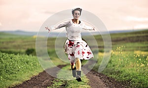 Gorgeous woman running on a countryside road
