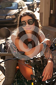 Gorgeous woman on a vintage motorcycle