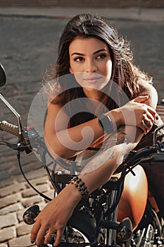 Gorgeous woman on a vintage motorcycle