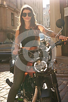 Gorgeous woman on a vintage motorcycle